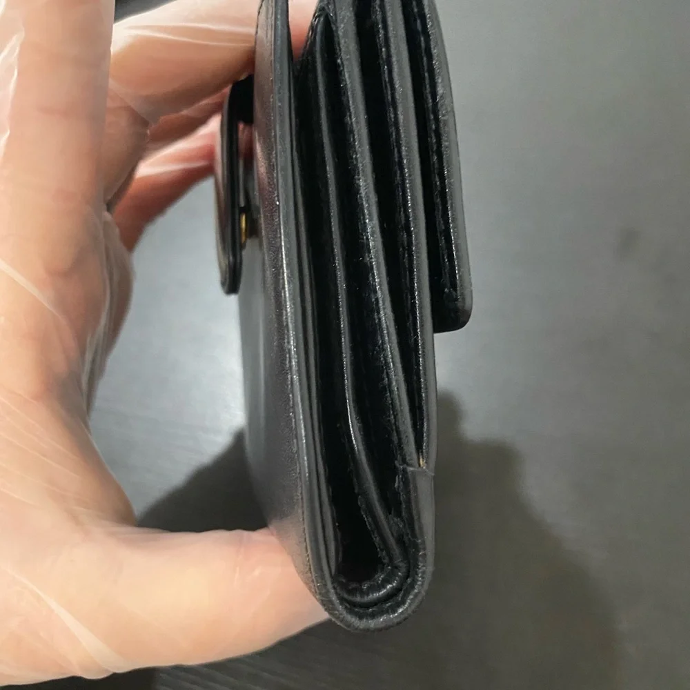 Authentic Ferragamo black leather trifold wallet gold with callouts